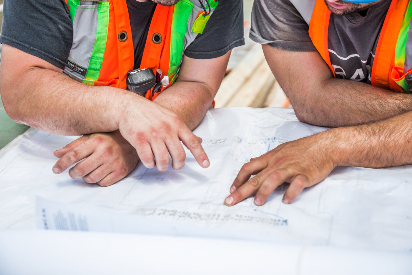 Site engineers checking a paper drawing together