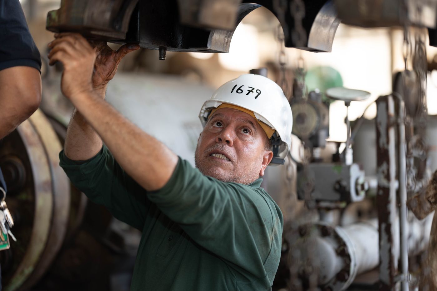 An engineer inspecting industrial machinery