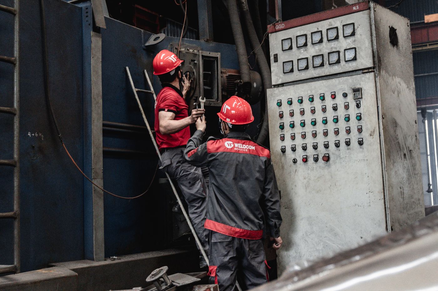 Technicians servicing industrial equipment