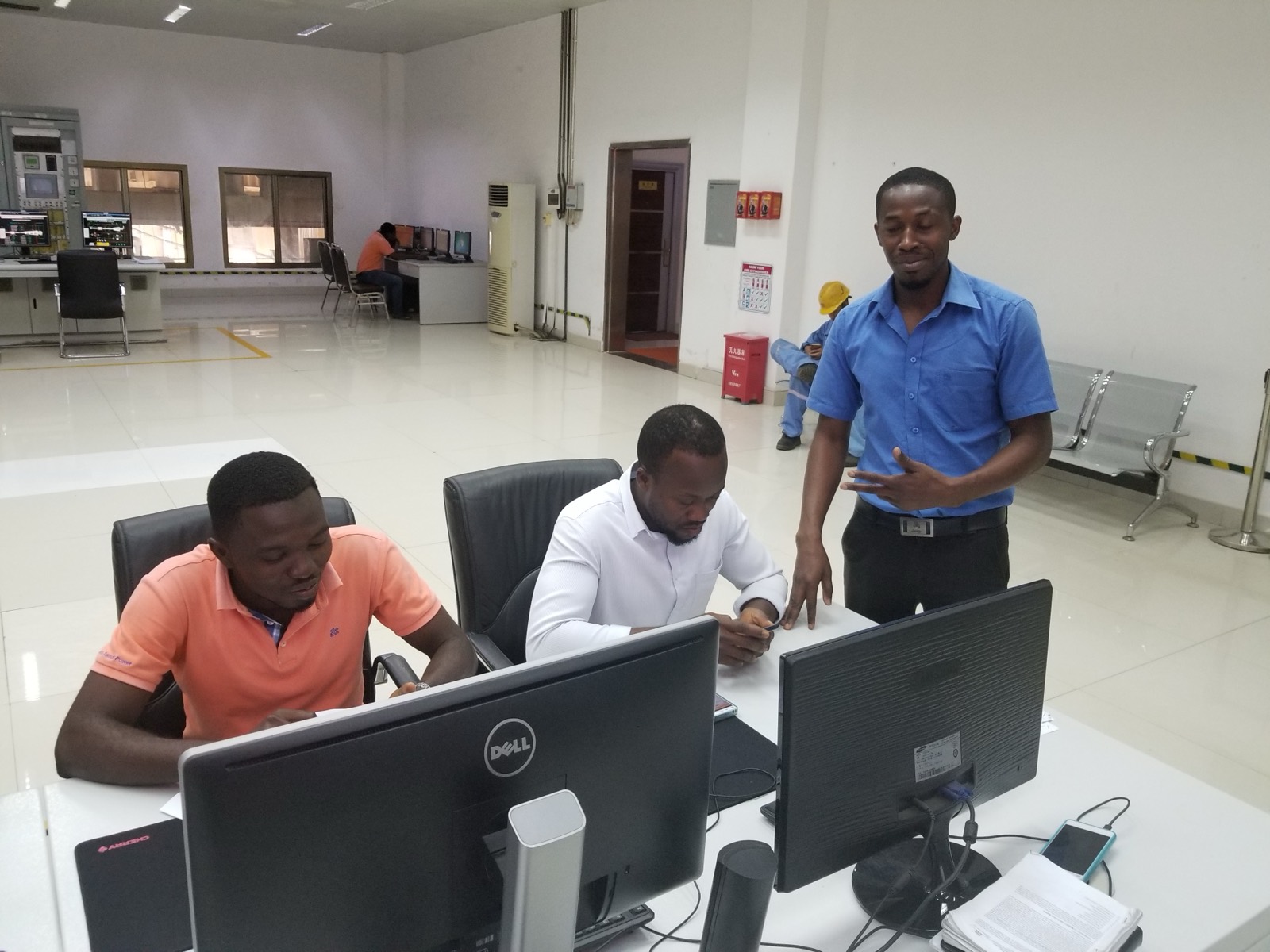 Engineers reviewing documents together at workstations