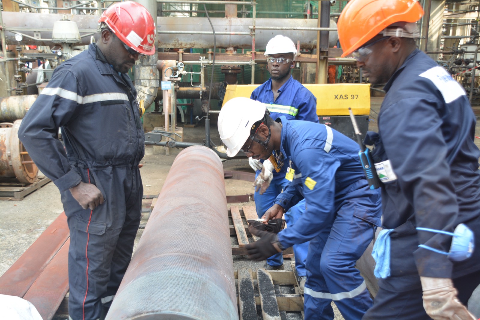 Crew working on a piping spool during project execution